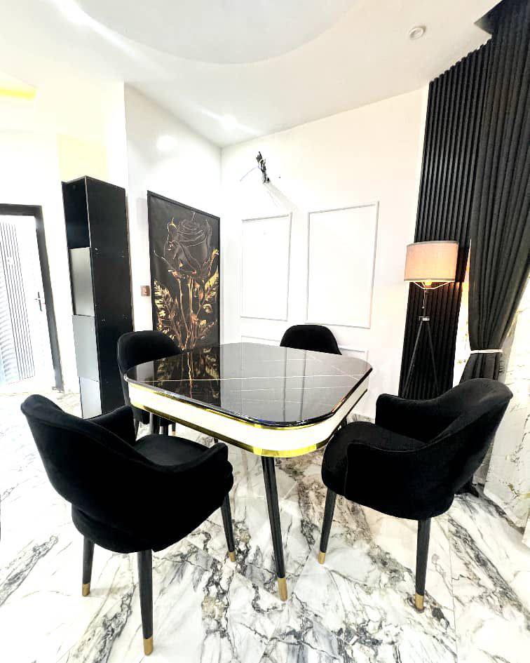 The dining area in one of our Abuja AstroStay apartments. Business guests regularly use the dining table as a secondary workspace for document reviews or small team meetings.